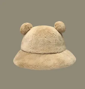 Close-up detail of cute beige faux fur bucket hat with bear ears for winter warmth