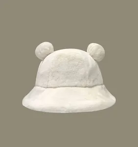 Close-up view of a soft white plush bucket hat with cute 3D bear ears for winter
