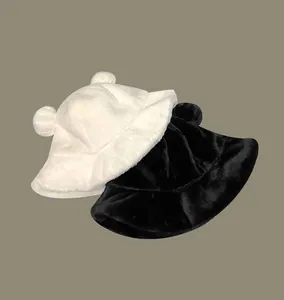 Close-up detail showing the soft plush texture of black and white bear ear bucket hats