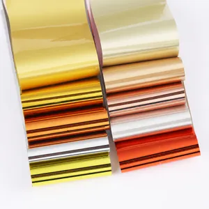Detailed macro shot of ten assorted metallic nail art transfer foils in vibrant colors