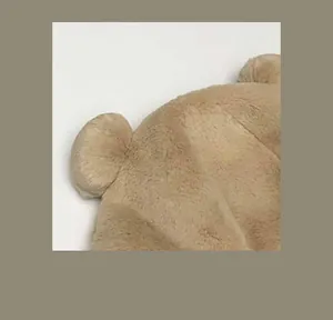 Close-up macro detail of the soft furry teddy bear ear on a winter plush bucket hat