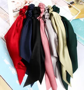 A collection of colorful satin ribbon hair scrunchies with elegant silky texture