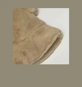 Detailed macro view showing the soft and thick faux fur texture of the beige winter bucket hat