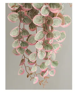 Detailed view of artificial pink and green variegated heart leaf hanging vine decor