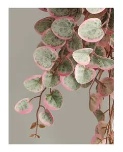 Detail view of artificial heart-shaped vine leaves with pink and green texture