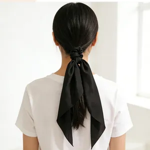 Elegant black satin hair scarf with long ribbons for a minimalist ponytail style