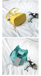 Detailed view of yellow and turquoise canvas bucket bags with lifestyle accessories