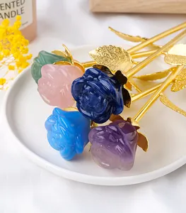 Detailed view of natural gemstone roses with golden stems on a white ceramic plate