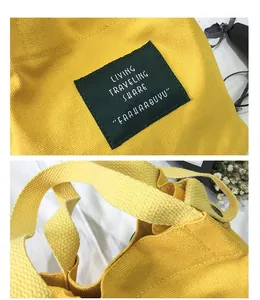 Close-up of yellow canvas bucket bag showing fabric texture and branding patch
