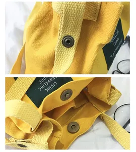 Detailed view of yellow canvas bucket bag showing magnetic snap closure and fabric texture