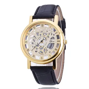 Detailed macro view of a men's skeleton quartz watch with gold case and black strap