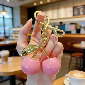 Elegant pink double cherry keychain with a gold-plated lobster clasp for women's bags and keys