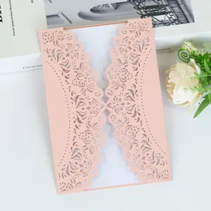 Elegant laser-cut wedding invitation featuring intricate floral lace in dusty pink.