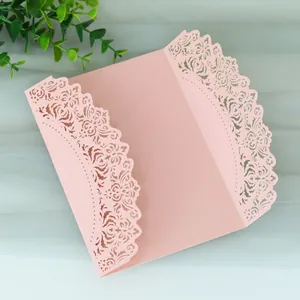 Elegant pink laser-cut wedding invitation card featuring intricate lace patterns