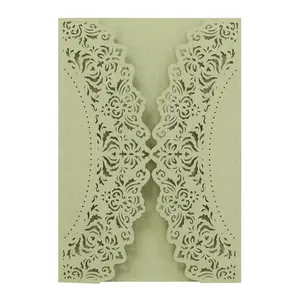 Detailed macro view of sage green laser-cut floral wedding invitation card with lace patterns