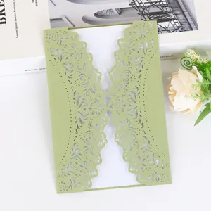 Elegant green laser-cut wedding invitation featuring intricate floral lace design details