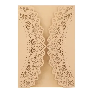 Detailed view of champagne laser-cut wedding invitation card with floral pattern