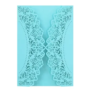 Detailed macro view of light blue laser-cut invitation card with floral patterns.