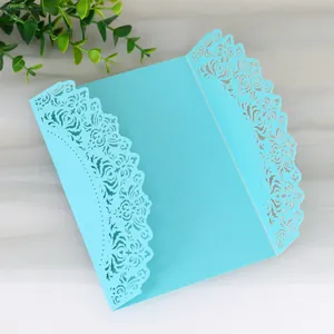Detailed view of laser-cut lace pattern on light blue gatefold wedding invitation