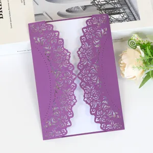 Elegant purple laser-cut wedding invitation card with intricate floral lace patterns