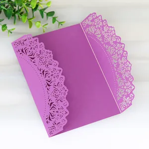 Elegant purple laser-cut lace wedding invitation card with intricate floral detail.