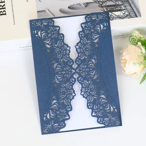 Detail shot of navy blue laser-cut wedding invitation with intricate floral pattern