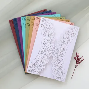 Detailed view of colorful laser-cut invitation cards with intricate floral pattern
