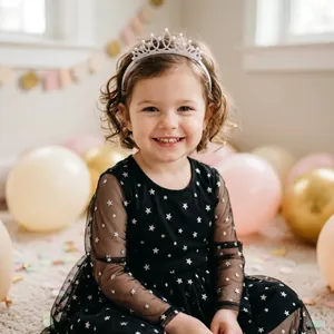 Close-up of a girl wearing a sparkling rhinestone princess crown headband for a birthday party.