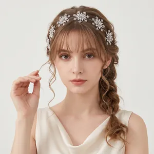 Close-up detail of a bridal snowflake rhinestone headband styled on a braided hairstyle.