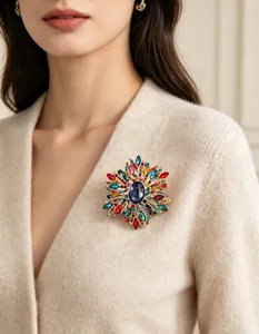 Grande broche en cristal coloré sur un pull en maille beige pour un look élégant
