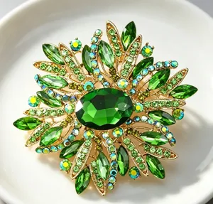 Gros plan d'une broche florale en cristal vert avec des pierres facettées sur alliage.