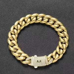 Detail view of gold Cuban link chain with zircon-paved clasp and distinctive S logo