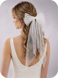 Detailed view of white tulle bridal hair bow veil embellished with delicate pearls