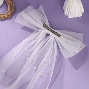 Elegant white tulle bow hair clip with faux pearls and short bridal veil for wedding