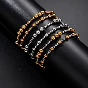 Detailed view of 18K gold plated and silver stainless steel beaded elastic bracelets