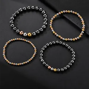 Detailed macro view of four mixed metallic beaded elastic bracelets on a dark backdrop