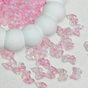 Close-up of pink glass bow beads 14x10mm for DIY jewelry making accessories