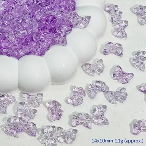 Detail view of purple transparent glass bow beads 14x10mm for DIY jewelry making