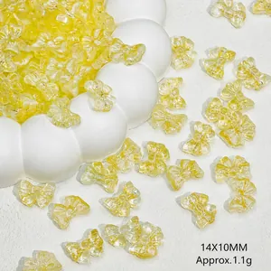 Macro view of 14x10mm yellow translucent glass bow beads for DIY jewelry making
