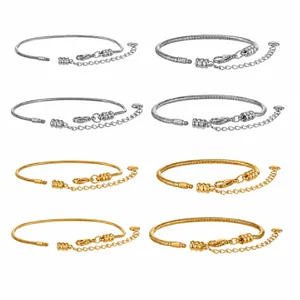 Detailed macro view of DIY snake bone bracelets in gold and silver stainless steel