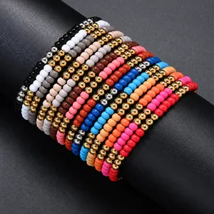 Detailed close-up showing a stack of vibrant matte polymer clay heishi bead stretch bracelets