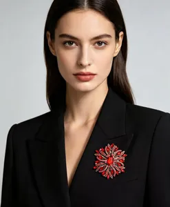 Detailed view of an elegant red crystal flower brooch pinned to a luxury black blazer lapel