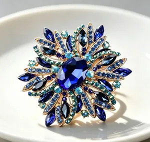 Close-up detail of luxury navy blue crystal flower brooch with shimmering rhinestone accents