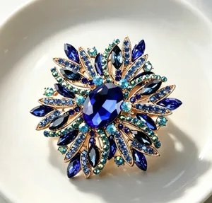 Macro view of a luxurious blue crystal brooch with intricate rhinestone floral details