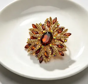 Detailed view of elegant vintage flower brooch with amber crystals and gold finish