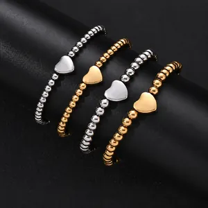 Detailed view of polished stainless steel heart bracelets in gold and silver finishes