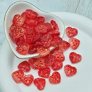 Detailed macro view of red translucent heart-shaped glass beads with textured surface