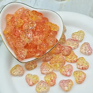 Detailed macro shot of orange heart-shaped glass beads with unique texture for DIY jewelry