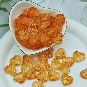 Close-up detail of amber heart-shaped lampwork glass beads for DIY handmade jewelry making