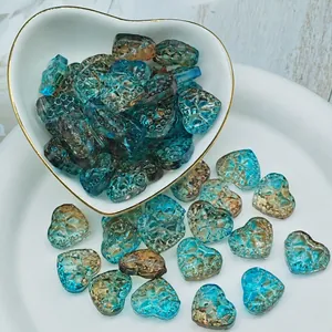 Detailed macro shot of textured heart-shaped blue and brown lampwork glass beads